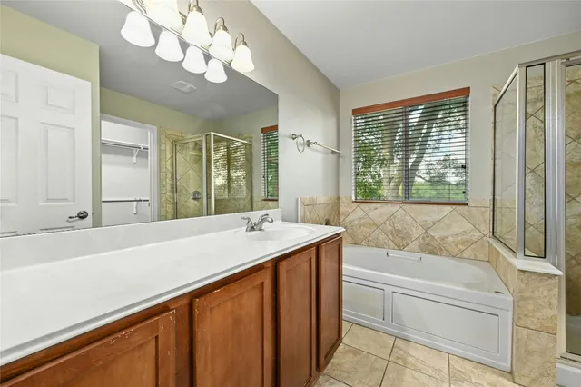 a bathroom with a tub sink and mirror