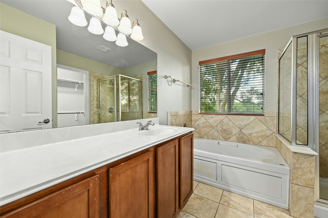 7614 Buck Meadow Drive Georgetown, TX 78628 - Photo 13 of 30 a bathroom with a tub sink and mirror