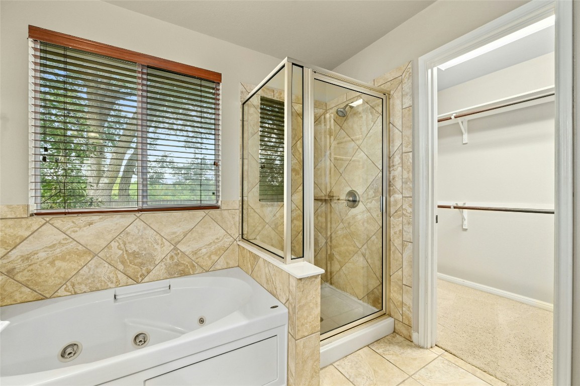 7614 Buck Meadow Drive Georgetown, TX 78628 - Photo 14 of 30 a bathroom with a bathtub and shower
