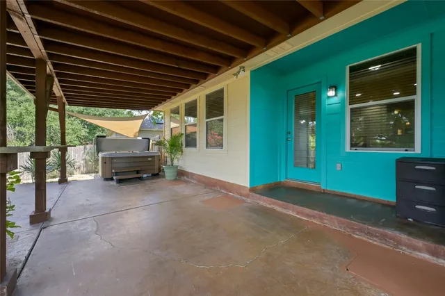 a view of backyard with deck and outdoor seating
