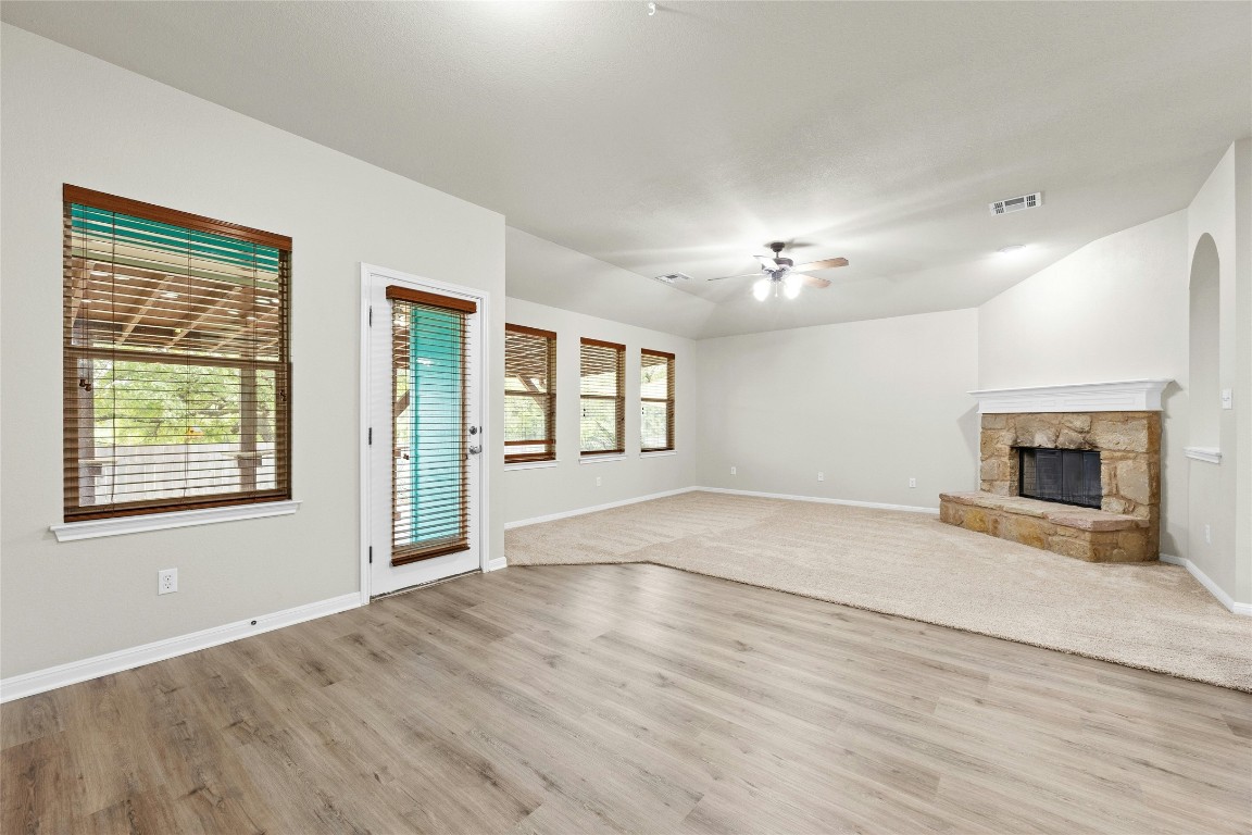 7614 Buck Meadow Drive Georgetown, TX 78628 - Photo 8 of 30 a view of an empty room with a fireplace and a window