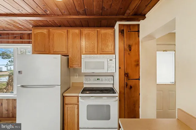 a kitchen with a refrigerator and a stove