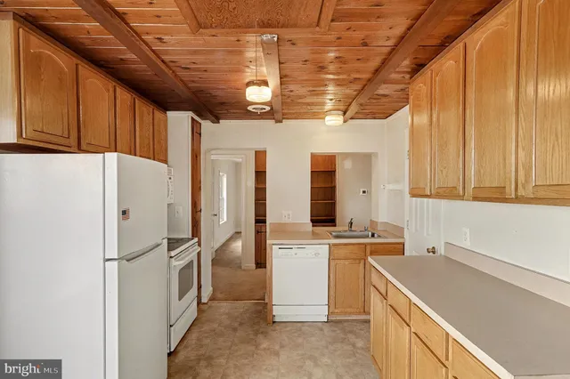 a kitchen with a sink a refrigerator and window