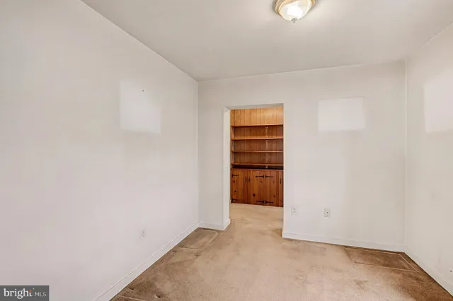 a view of a hallway with a bathroom