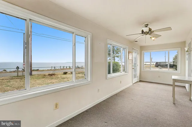 a view of open kitchen with furniture and large windows