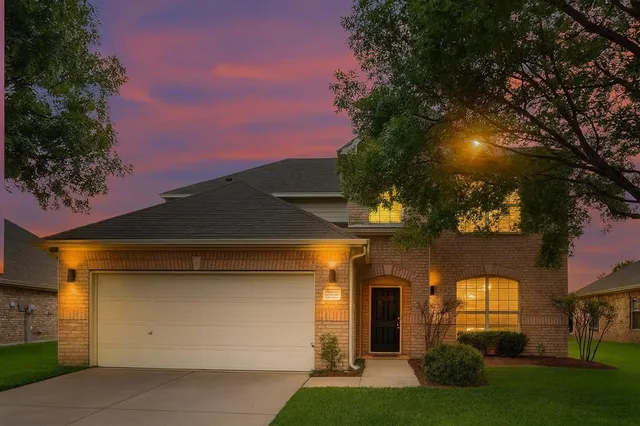 a front view of a house with a yard and outdoor seating