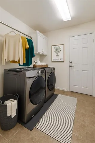 a utility room with sink dryer and washer