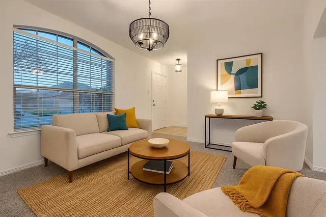 a living room with furniture and a large window