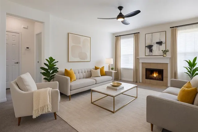 a living room with furniture a fireplace and a window