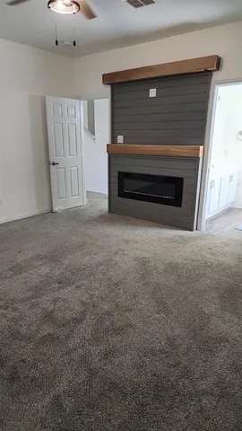 a view of empty room with a fireplace