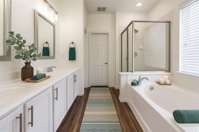 a bathroom with a tub sink and mirror