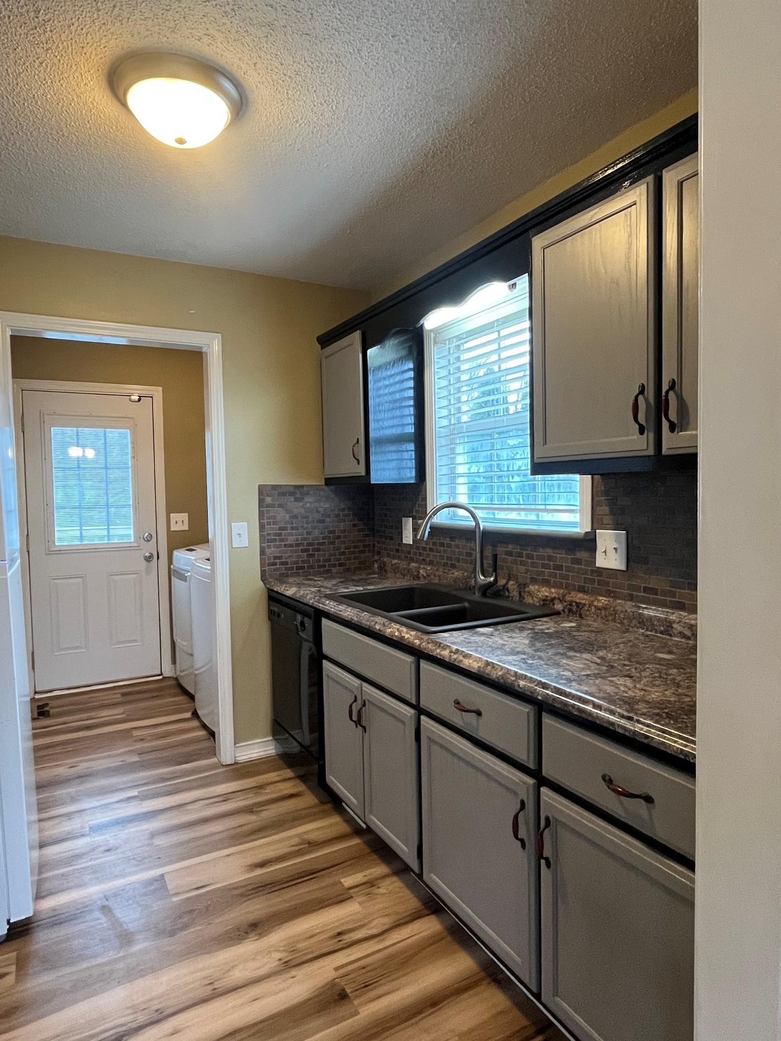 404 Sideline Drive Oak Grove, KY 42262 - Photo 3 of 14 a kitchen with granite countertop wooden cabinets a sink and dishwasher