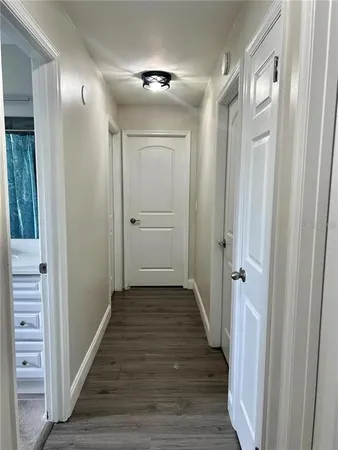 a view of a hallway with wooden floor
