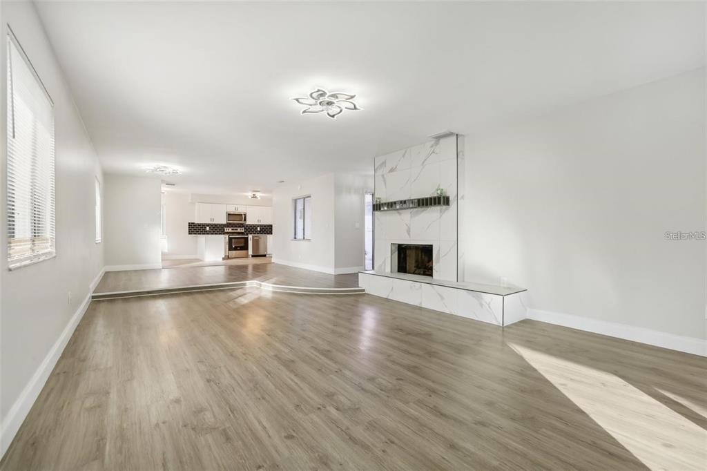 1052 Manchester Circle Winter Park, FL 32792 - Photo 6 of 41 a view of empty room with wooden floor and fireplace