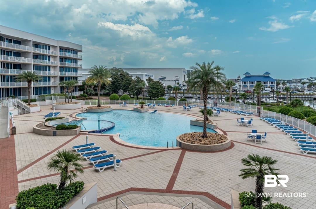 27800 Canal Road, Unit 212 Orange Beach, AL 36561 - Photo 36 of 43 Pool with fence and a patio area