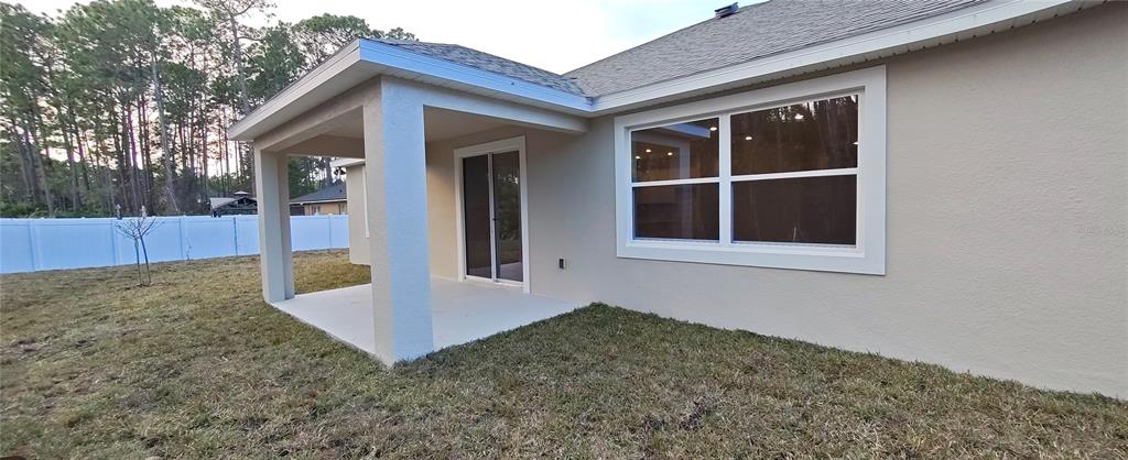 3 Undermount Path East Palm Coast, FL 32164 - Photo 11 of 13 a view of house with backyard and trees