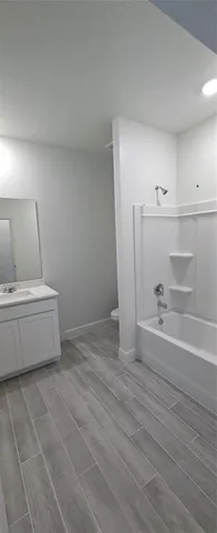 a view of a room with wooden floor and cabinet