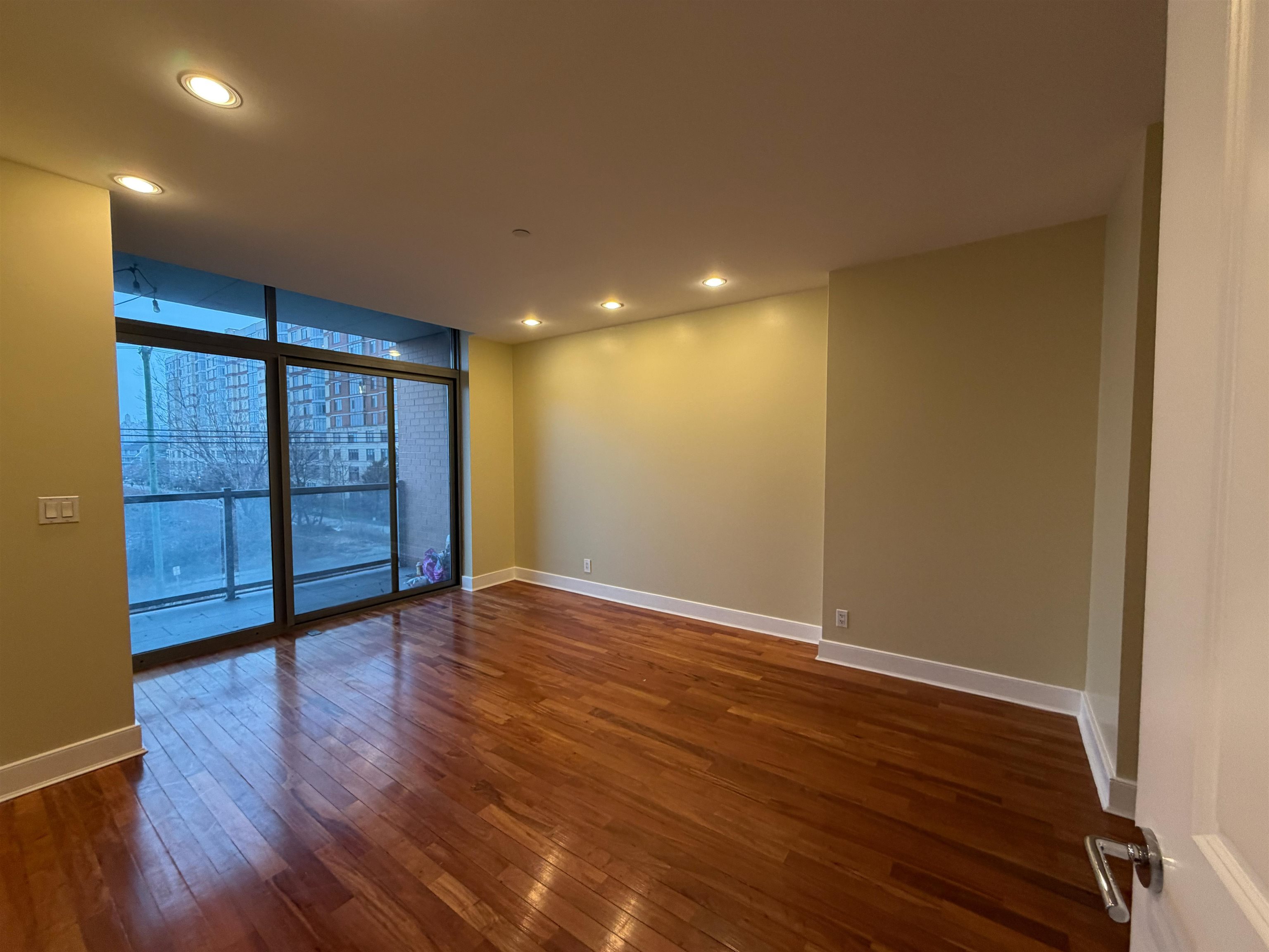 8125 River Road, Unit 3C North Bergen, NJ 07047 - Photo 13 of 24 a view of an empty room with wooden floor and a window