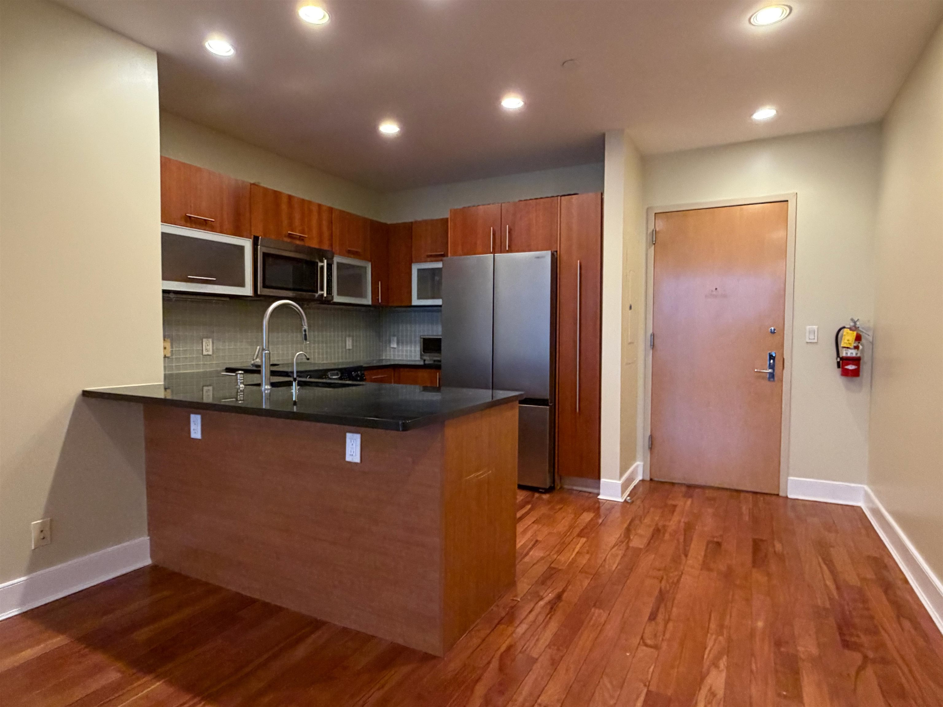 8125 River Road, Unit 3C North Bergen, NJ 07047 - Photo 5 of 24 a kitchen with stainless steel appliances granite countertop a refrigerator a sink and a stove