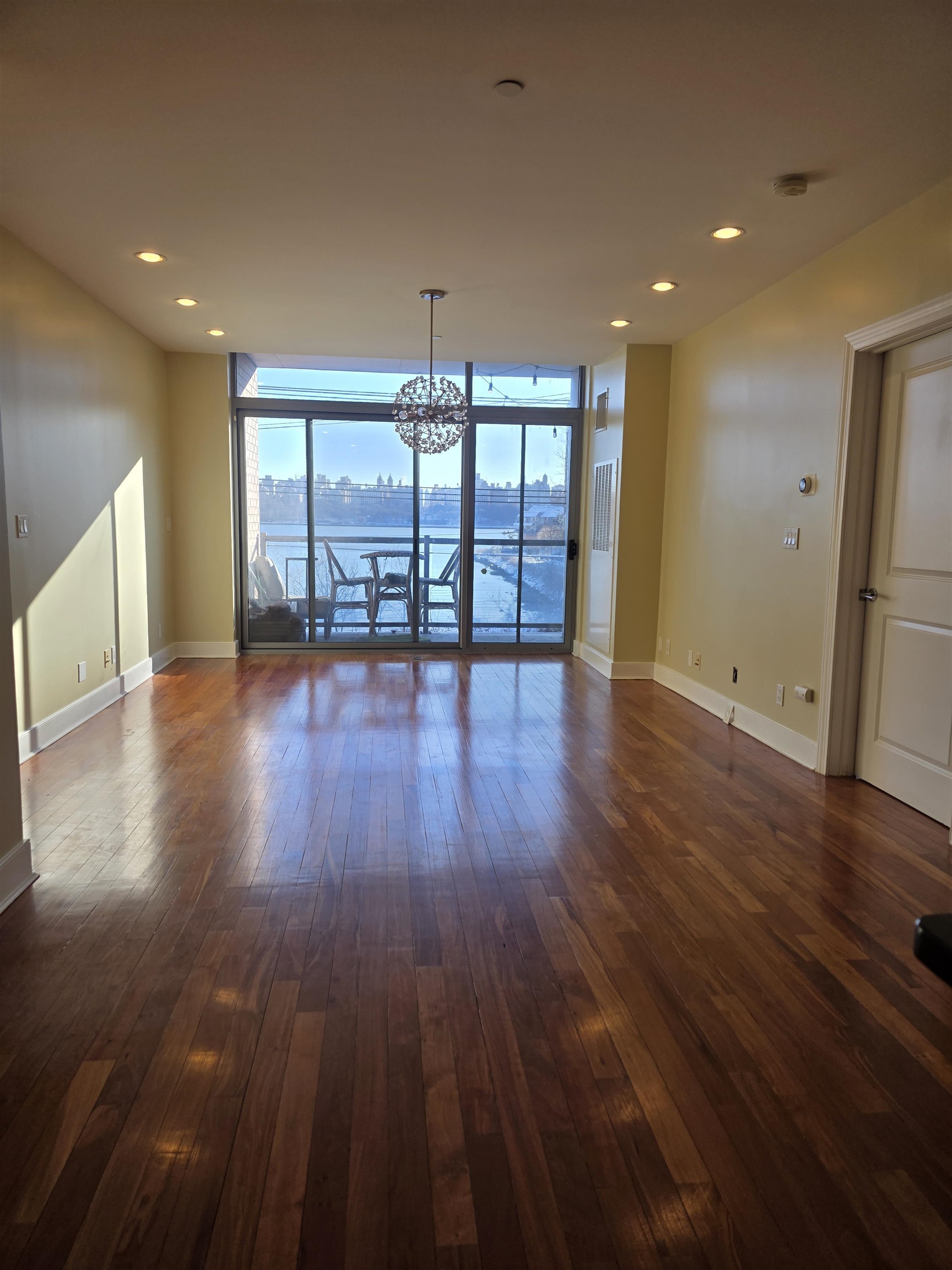 8125 River Road, Unit 3C North Bergen, NJ 07047 - Photo 6 of 24 a view of an empty room with wooden floor and a window