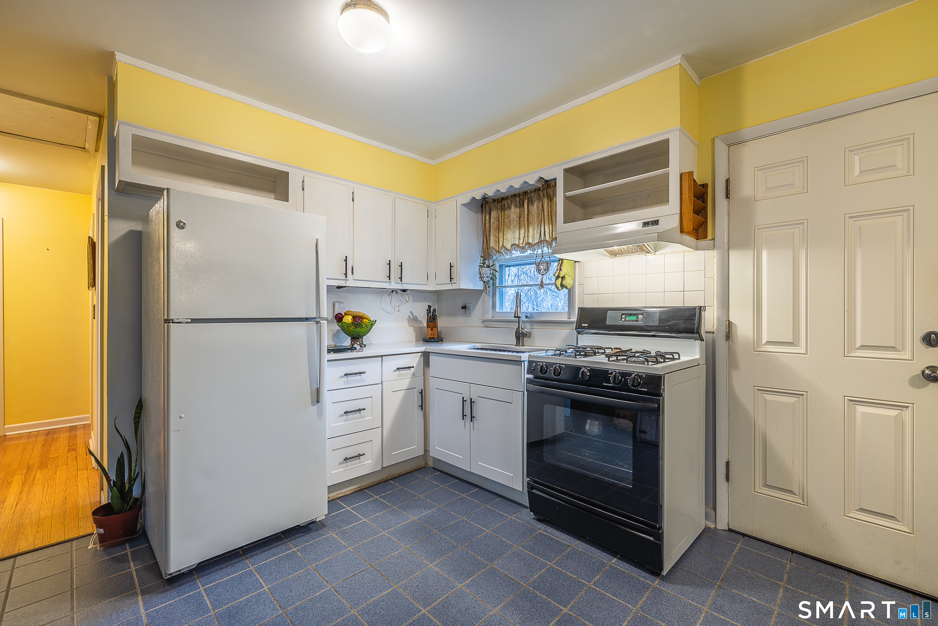 130 Holroyd Street Bridgeport, CT 06606 - Photo 11 of 29 a kitchen with cabinets stainless steel appliances and a window
