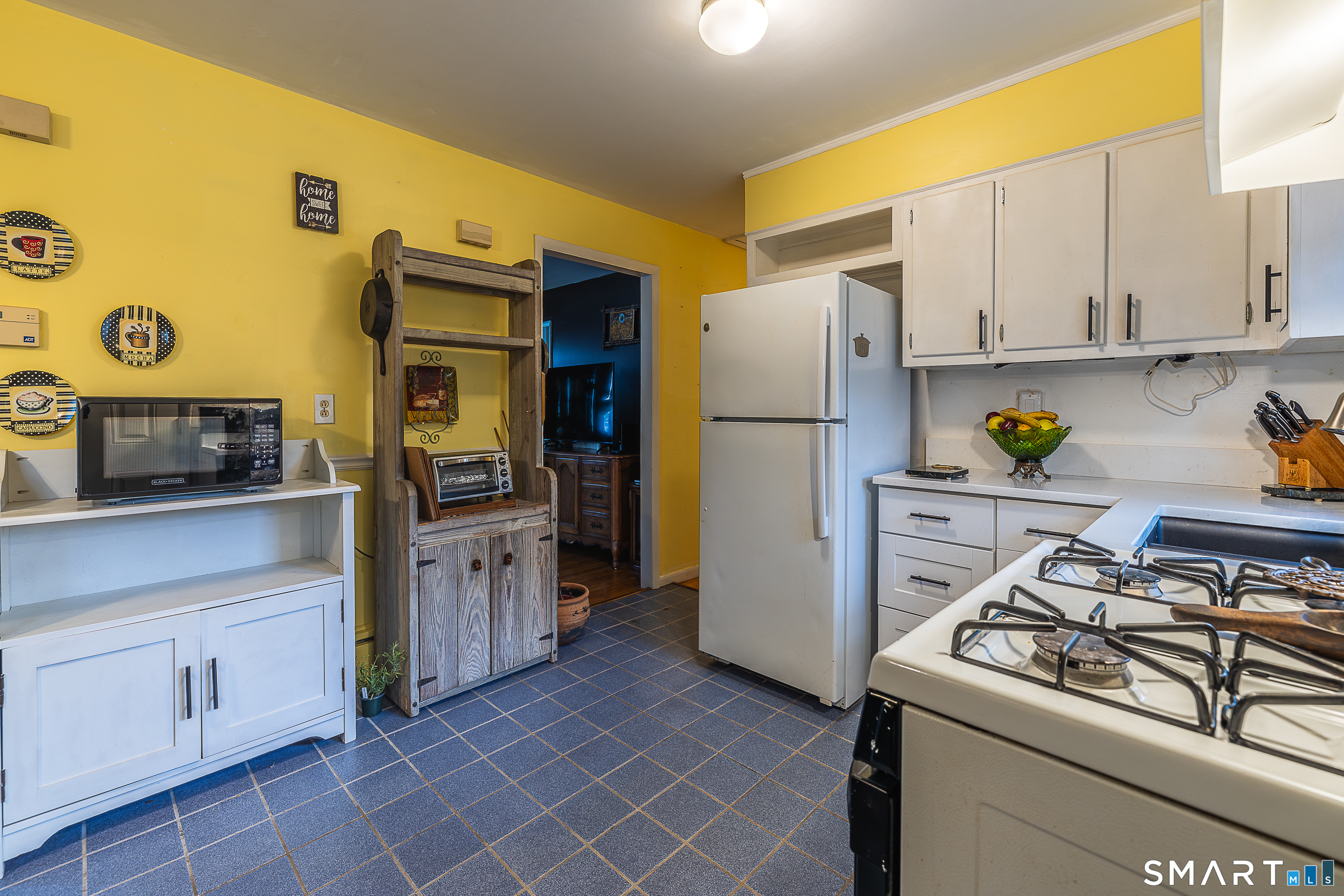 130 Holroyd Street Bridgeport, CT 06606 - Photo 13 of 29 a kitchen with stainless steel appliances a stove a refrigerator and cabinets