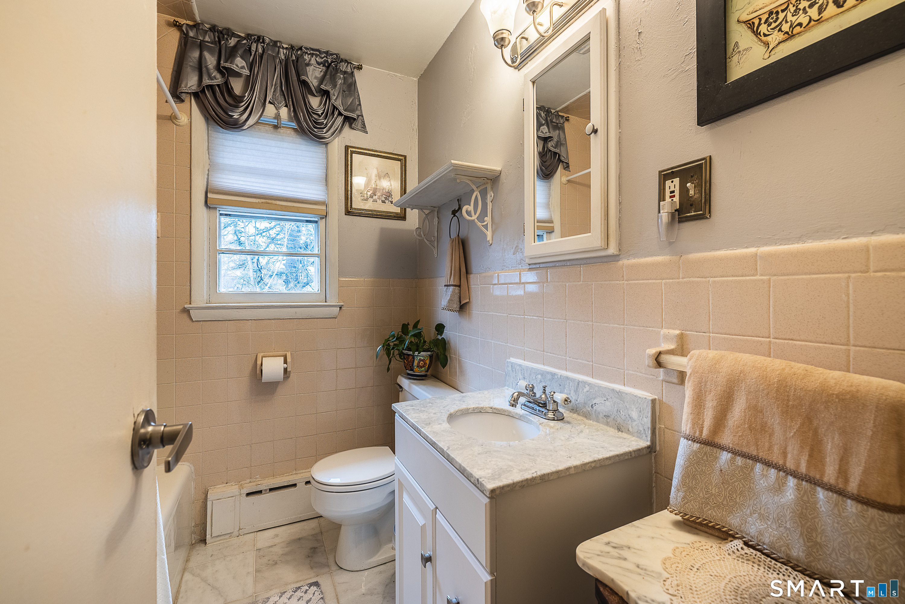 130 Holroyd Street Bridgeport, CT 06606 - Photo 14 of 29 a bathroom with a granite countertop toilet sink and mirror