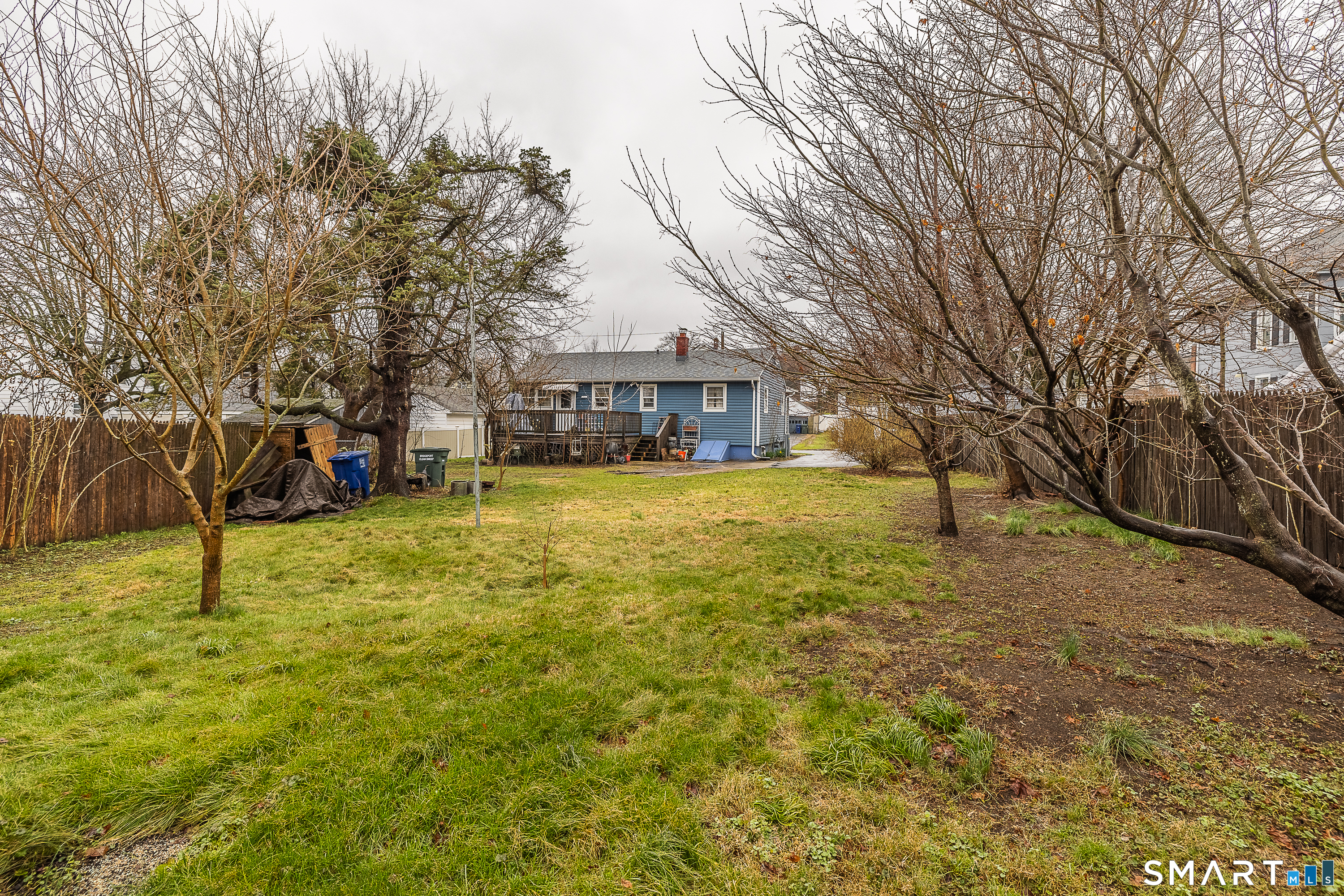 130 Holroyd Street Bridgeport, CT 06606 - Photo 23 of 29 a view of a house with a yard and large trees