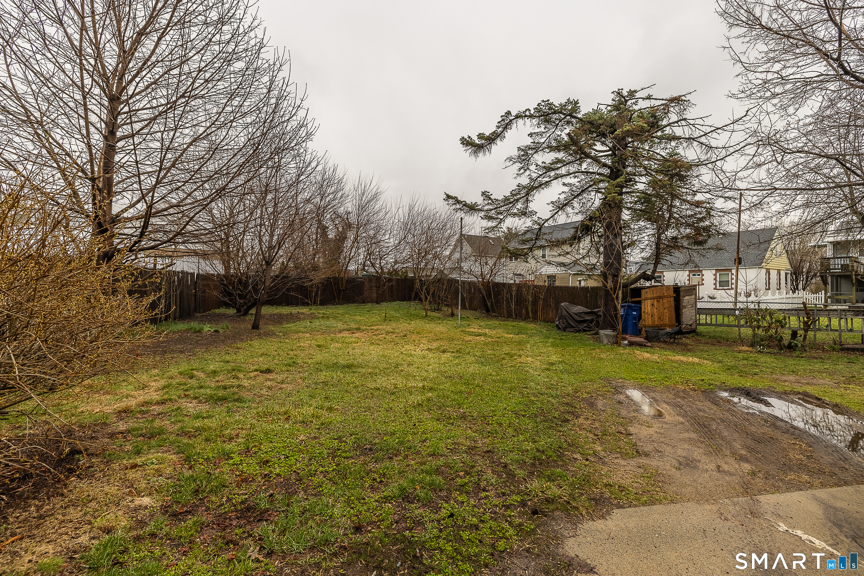 130 Holroyd Street Bridgeport, CT 06606 - Photo 24 of 29 a backyard of a house with a table and chairs
