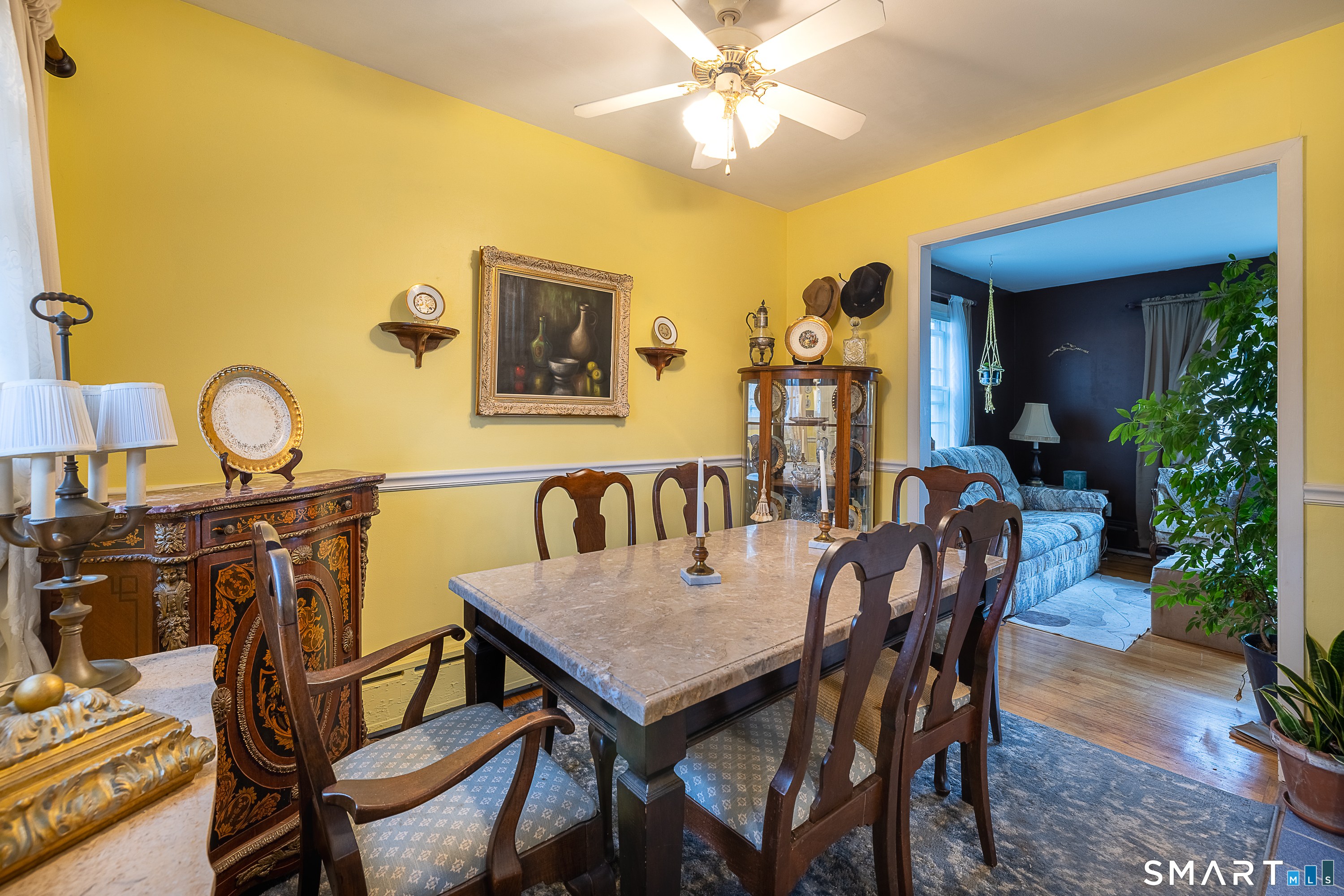 130 Holroyd Street Bridgeport, CT 06606 - Photo 9 of 29 a view of a dining room and livingroom with furniture