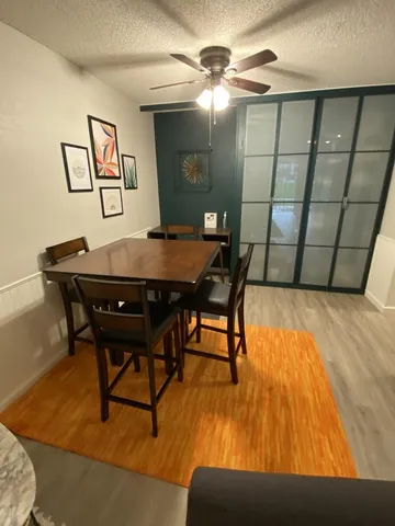 a view of a dining room with furniture and wooden floor