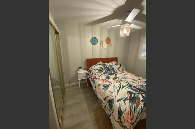 a bed sitting in a bedroom next to a window