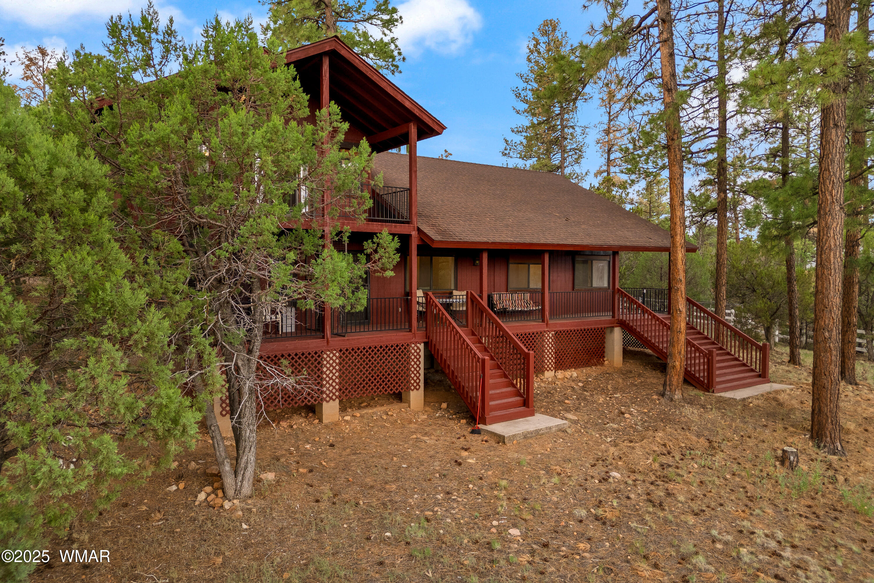 3045 Aspen Road Overgaard, AZ 85933 - Photo 3 of 42 a backyard of a house with barbeque oven table and chairs