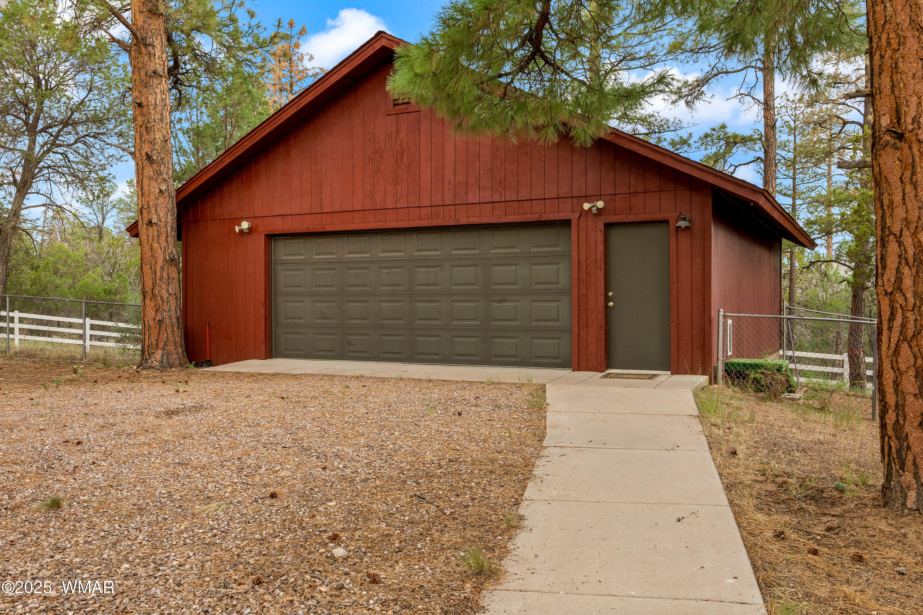 3045 Aspen Road Overgaard, AZ 85933 - Photo 33 of 42 a front view of a house with a yard and garage