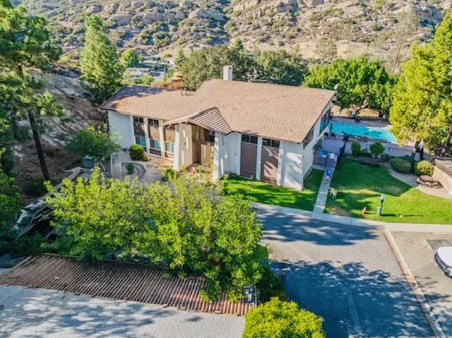 an aerial view of a house with garden space and street view