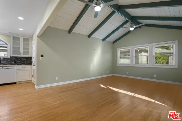 a view of a livingroom with an empty space and a window