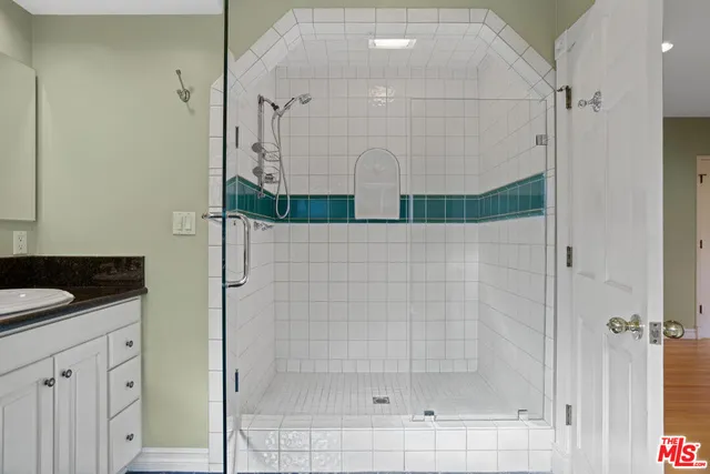a bathroom with a shower and a sink
