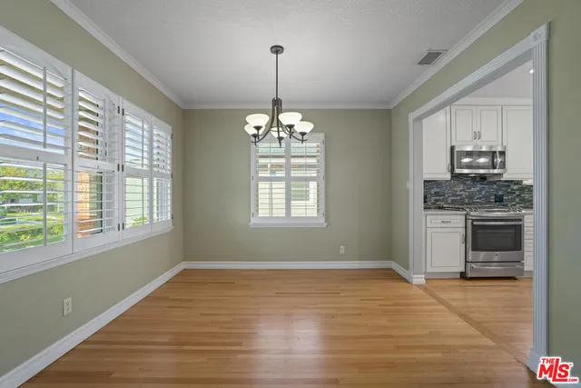 a view of a kitchen with stove and microwave