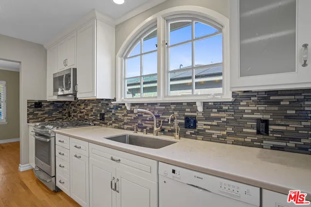 a kitchen with a sink and cabinets