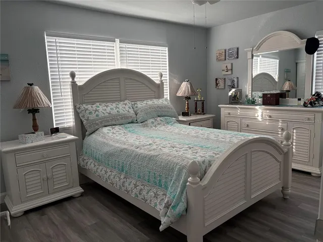 a bedroom with a large bed and a dresser