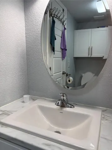 a bathroom with a sink and a mirror