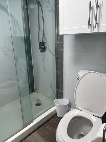 a bathroom with a toilet and a shower