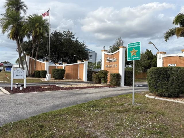 a view of a house with palm trees