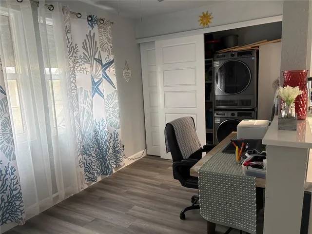 a view of a workspace with furniture and a window