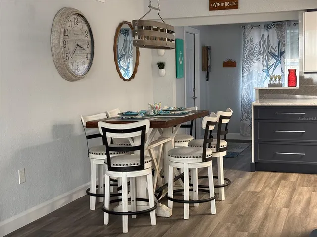 a dining room with furniture and wooden floor