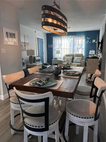 a kitchen with a table chairs a stove a dining table and chairs