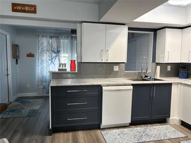 a kitchen with a sink cabinets and appliances