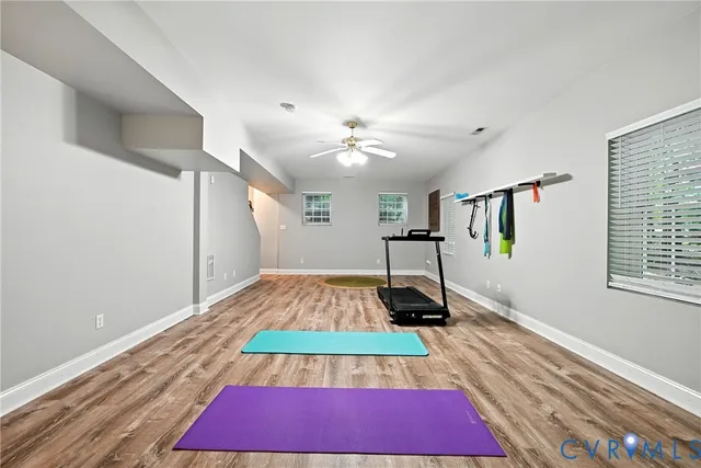 a room with pool table and wooden floor