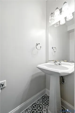 a bathroom with a sink a mirror and a toilet