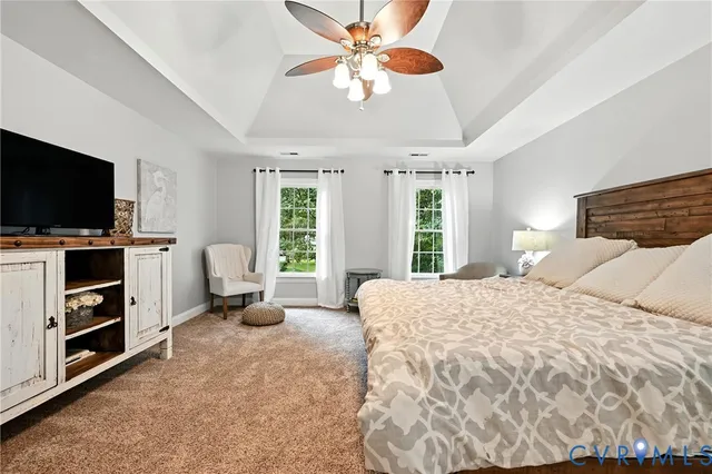 a bedroom with a bed and flat screen tv